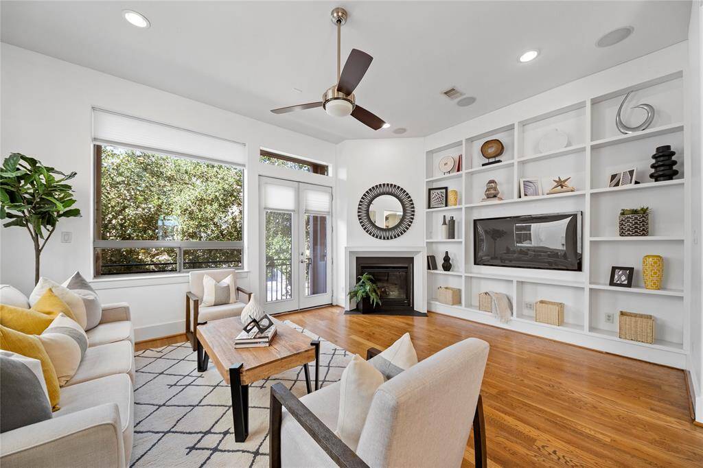 A spacious open floor plan w/ natural light, real hardwood floors and a gas burning fireplace give warmth to the room. There is a large, usable balcony off of the living room. This balcony is one of three outdoor living areas.