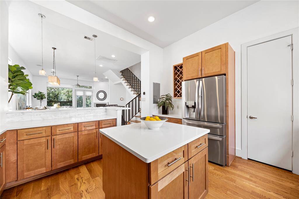 The kitchen has quartz counters, stainless steal appliances, and a walk-in pantry. The stainless steel french-door refrigerator stays with the home.