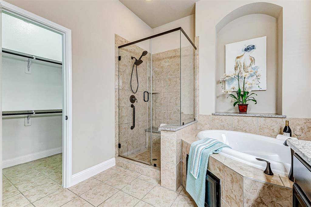 Spacious shower enclosed with glass doors