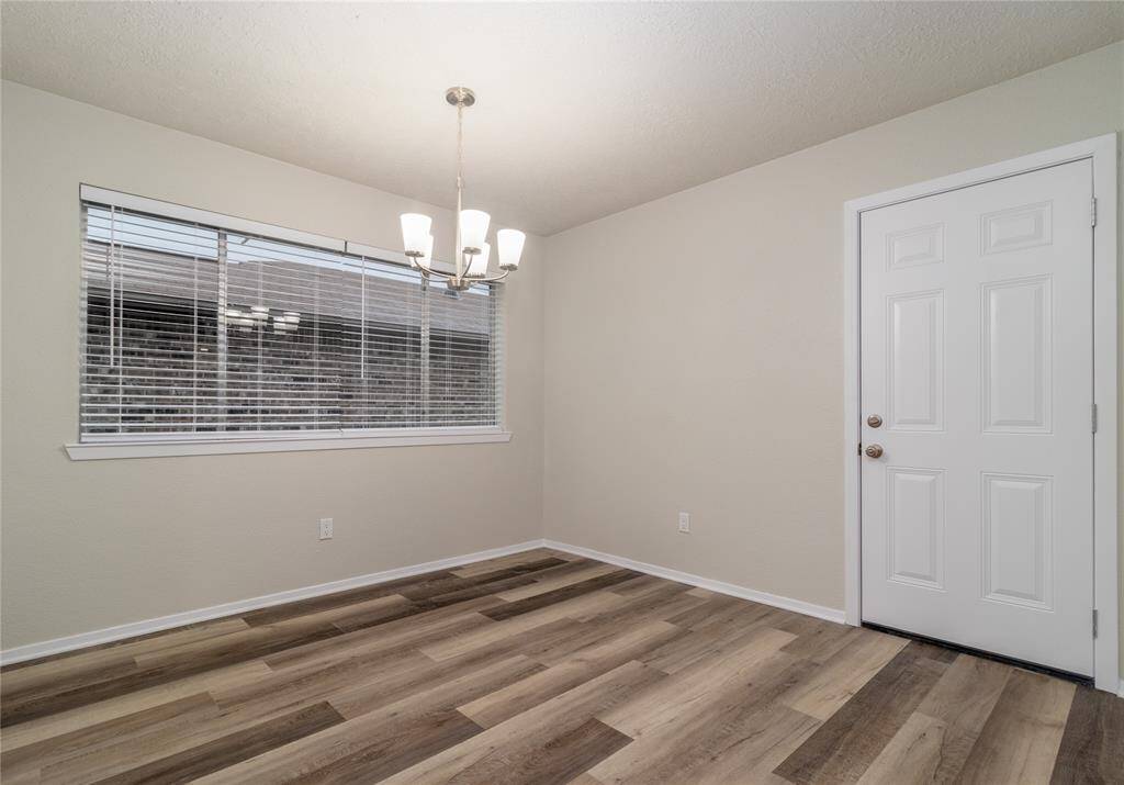 Dinning Room has wood flooring and new light fixture.