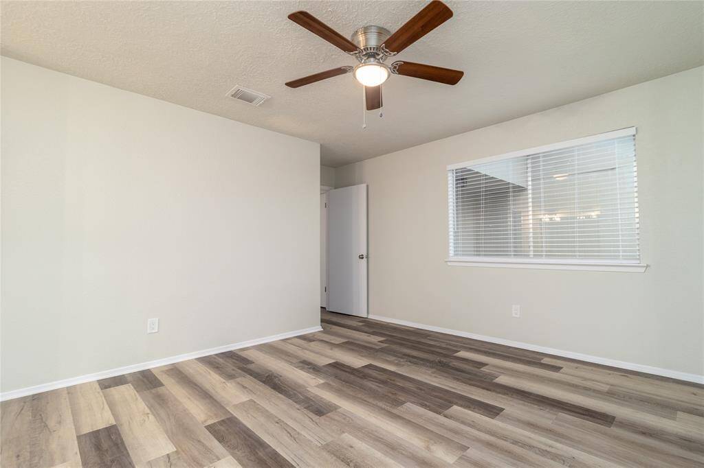 2nd Bedroom has a new ceiling fan and new wood flooring.