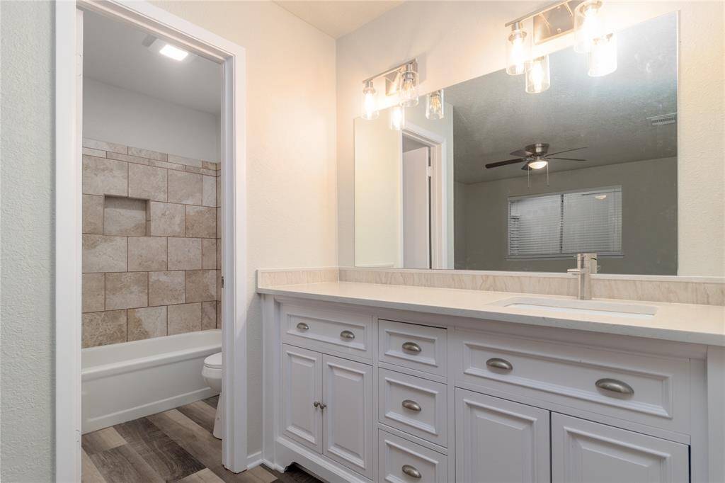 Main Bathroom has the sink and vanity in the Main Bedroom with new cabinets and granite counter tops. .