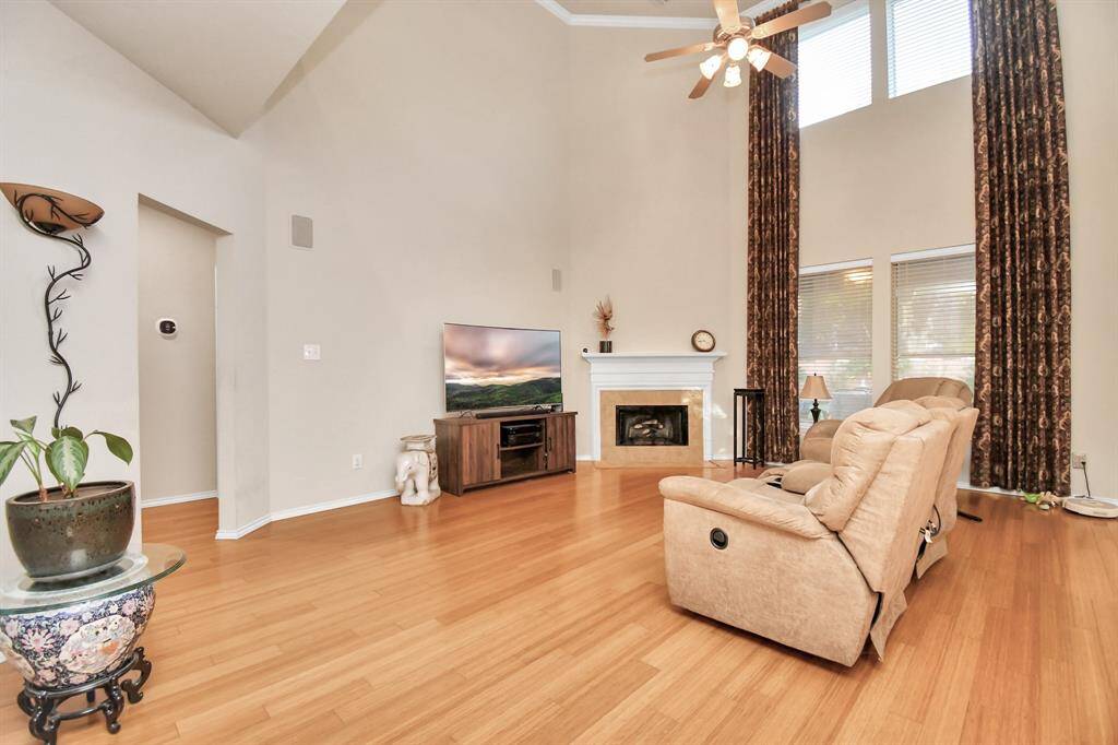 fireplace has gas logs but can be converted to real logs. Custom curtains will stay.