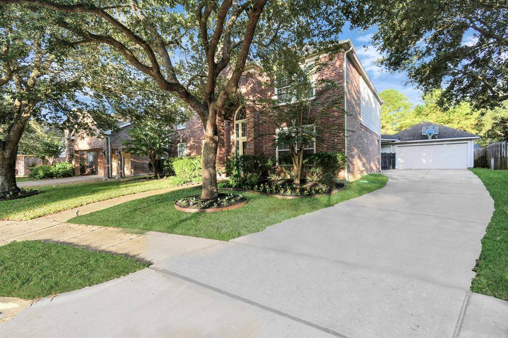 Long drive with Detached extended garage in rear