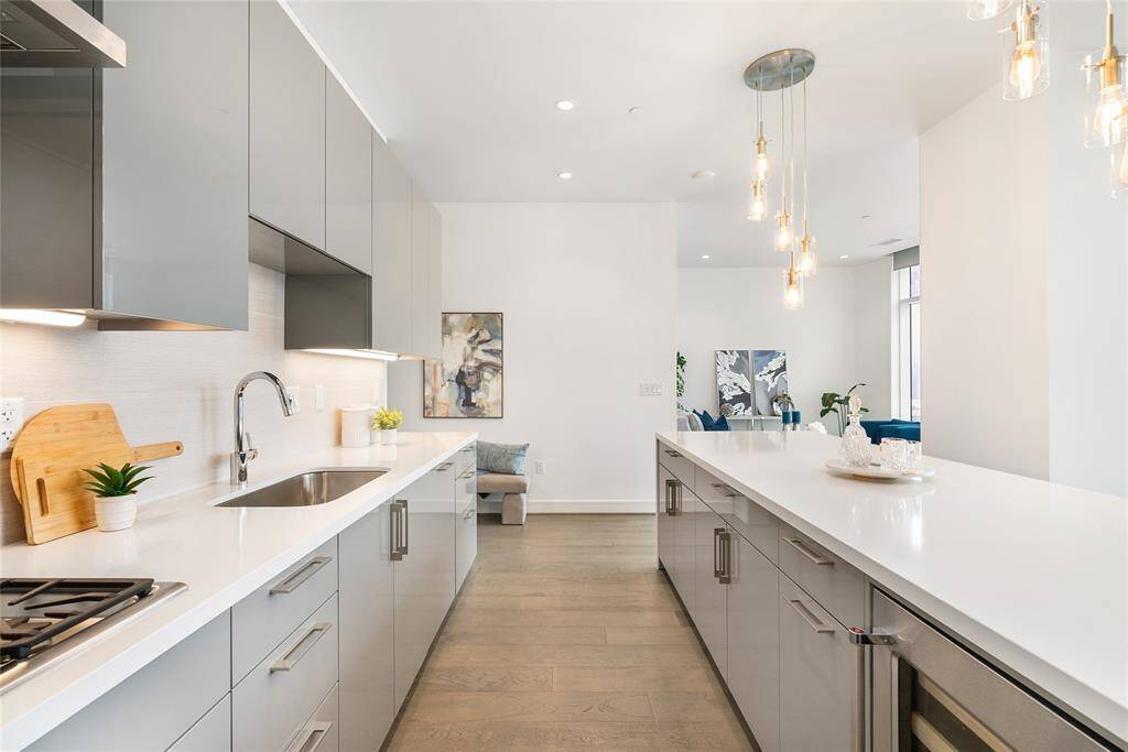 The kitchen is rich with sophisticated details including an abundance of cabinetry and extensive quartz counters