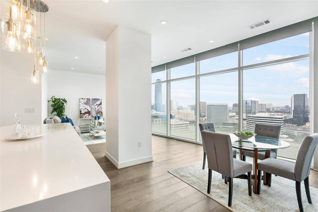 The wall to ceiling windows allow natural light to fill the home, and create a bright and airy feel throughout the living space!