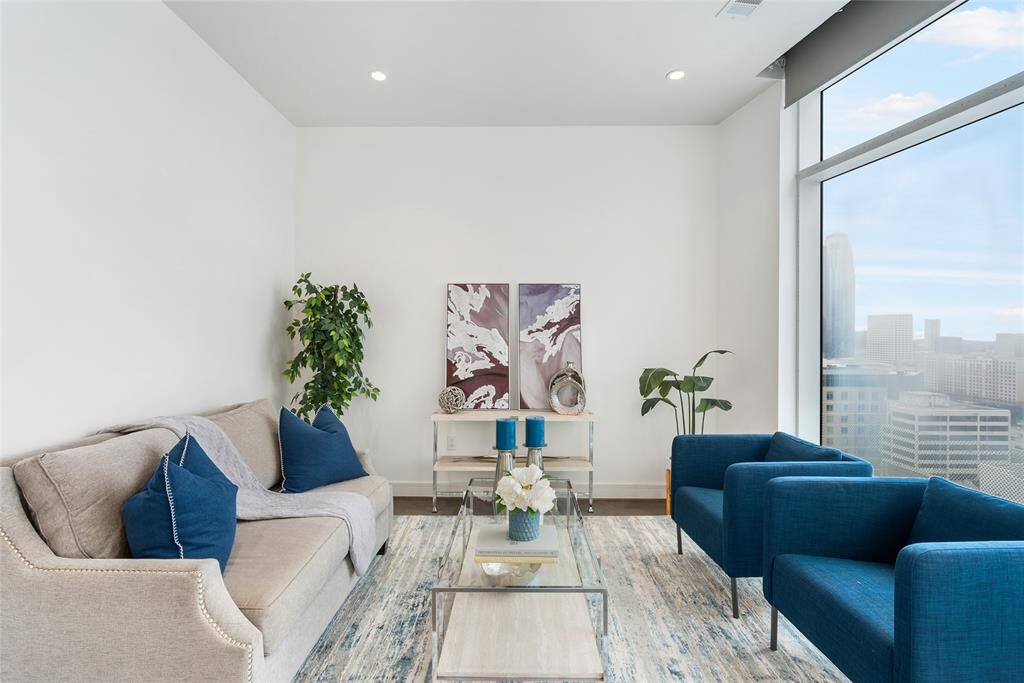 All living spaces have high ceilings, wood flooring and neutral paint, creating a modern aesthetic!
