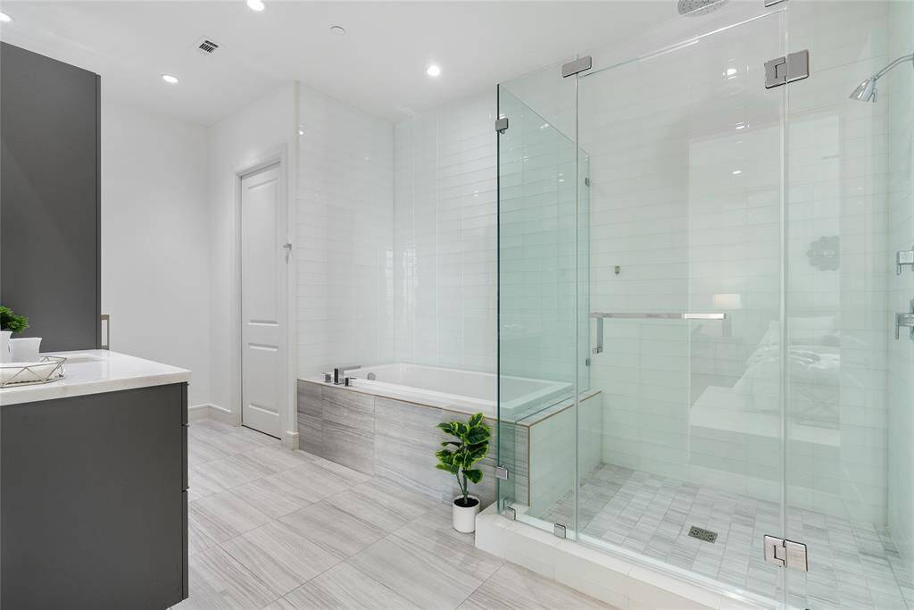 The primary bathroom is incredibly spacious with luxurious features all around!