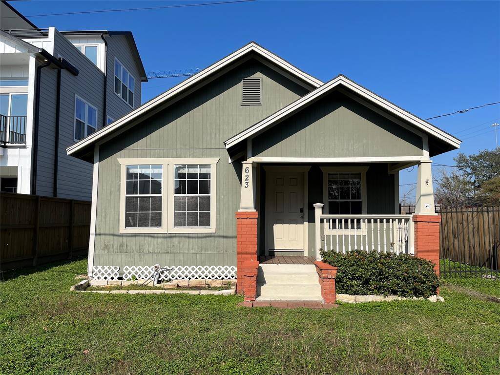 Charming single-story home with a cozy front porch, great facade, and red brick accents. Features a small yard. Ideal for buyers seeking a classic look with potential for updates.