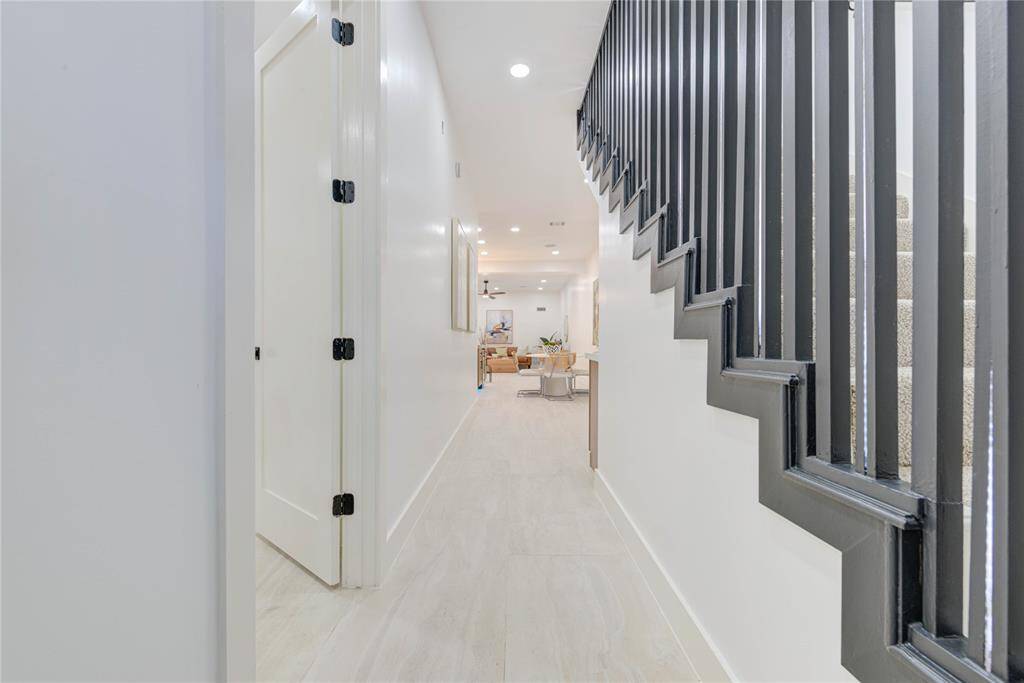 Upon entering, you're greeted by a spacious foyer featuring high ceilings, elegant light fixtures, and gleaming tile floors that set the tone for the rest of the home.