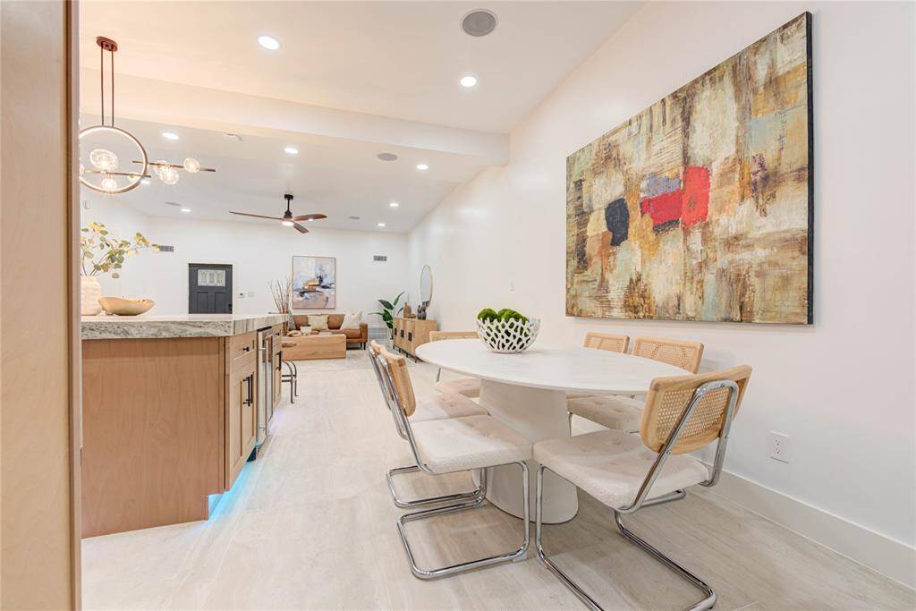 Adjacent to the kitchen, the formal dining space features a stylish chandelier, ample room for a large dining table, and easy access to the great room.