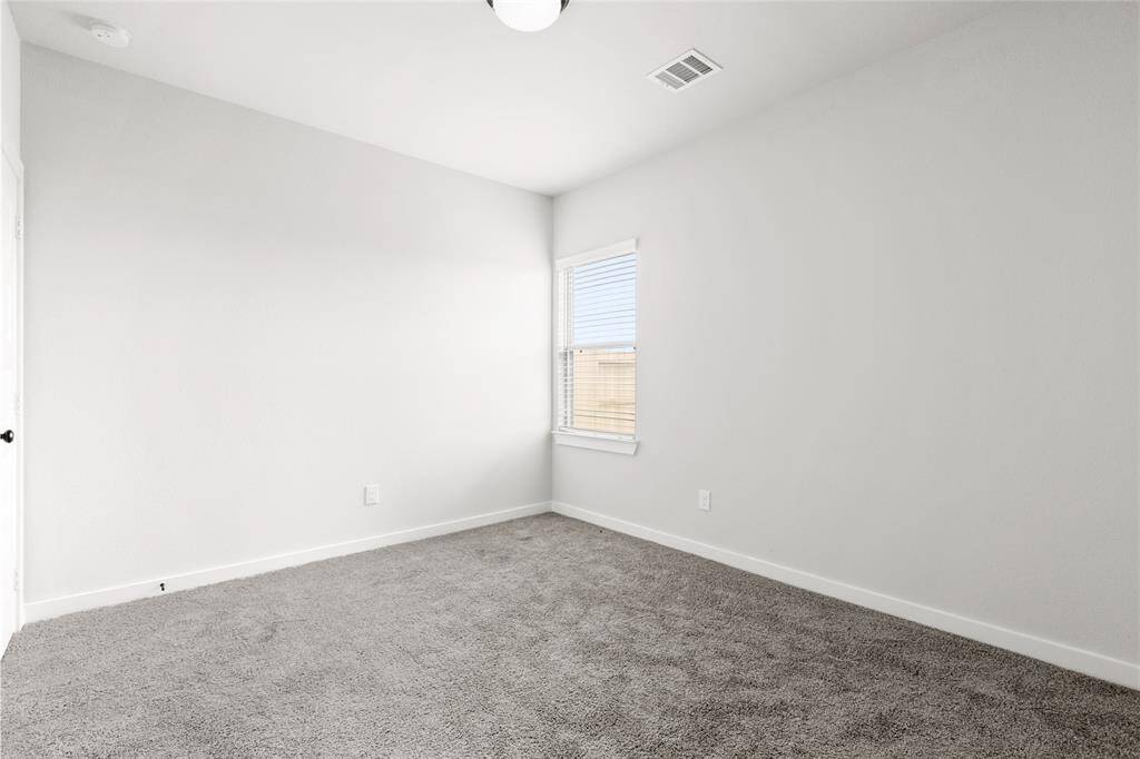 First floor guest suite or flex space with full bathroom and walk in closet.