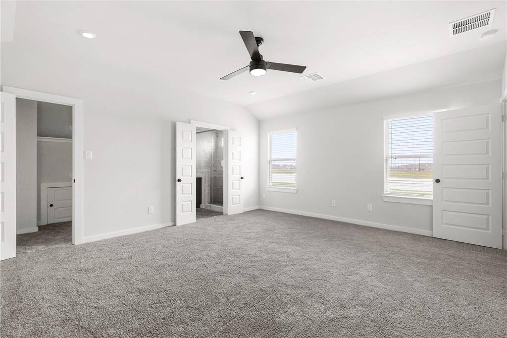 Primary room with lots of natural light, including window view of lake.