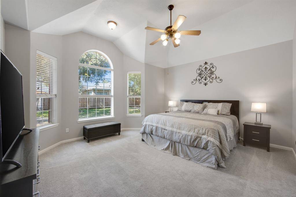 The primary ensuite offers a serene retreat with plush carpeting that adds comfort and warmth. Its tall ceiling and bay window create a spacious, airy feel, allowing plenty of natural light to fill the room and enhance the relaxing ambiance.