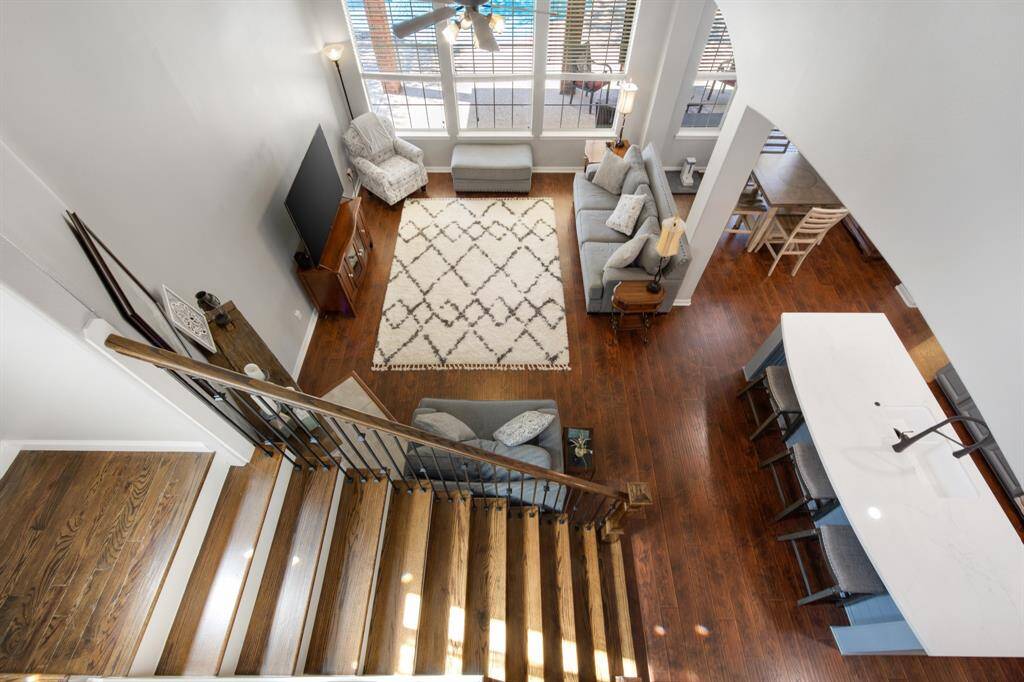 The stairs are enhanced with rich wood flooring and wrought iron spindles, adding a touch of elegance to the space. From the upstairs landing, you can enjoy a beautiful view looking down into the family room and kitchen, creating a sense of openness. Huge storage closet underneath the stairs with built-in shelving.