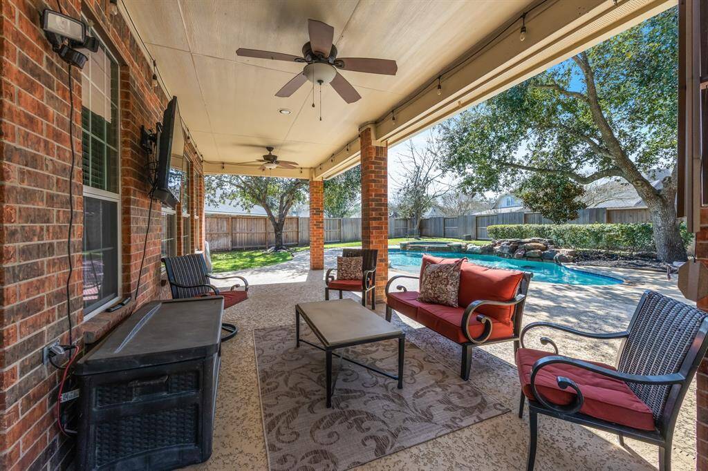 The backyard is a perfect outdoor retreat, featuring a spacious covered patio with ceiling fans to keep you cool on warm days. It's an ideal space for entertaining, dining al fresco, or simply relaxing while enjoying the tranquil surroundings. The covered patio provides comfort and shade, enhancing your outdoor living experience.