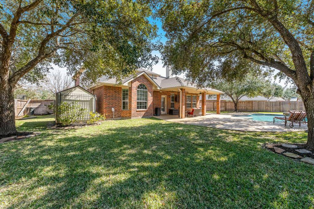 The backyard offers plenty of green space, providing a perfect area for kids to play and for furry pets to run and explore. It’s a great, open environment for outdoor fun and family activities.