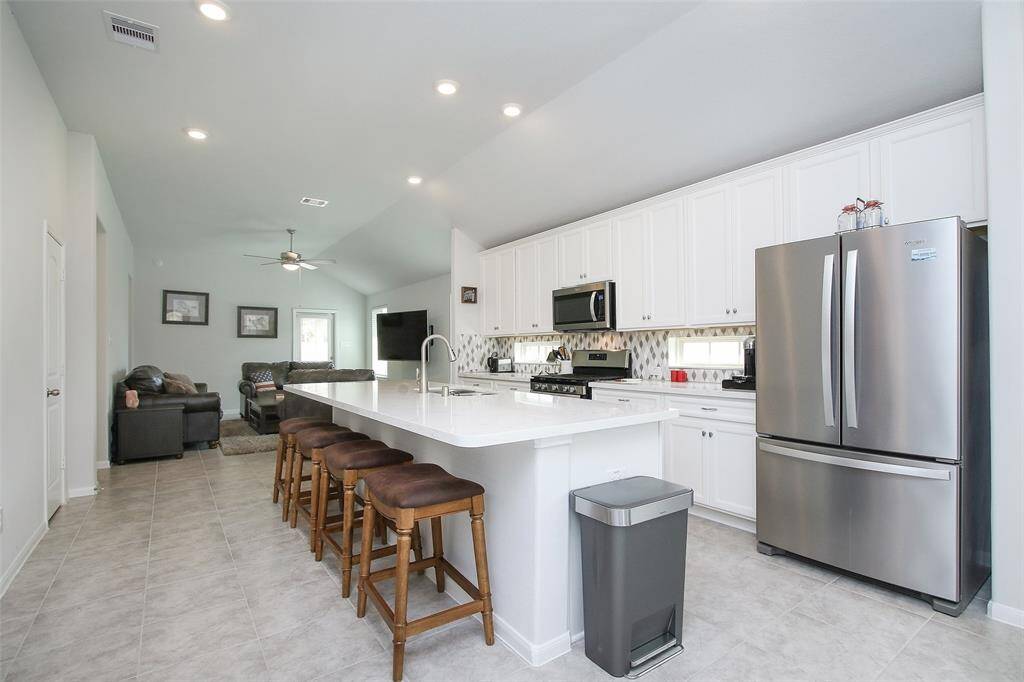 The island provides additional seating in this open concept home