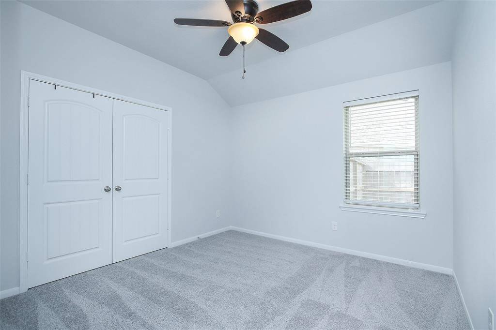 Bedroom #2- All of the bedrooms feature upgraded paneled doors, plush carpet, and a ceiling fan.