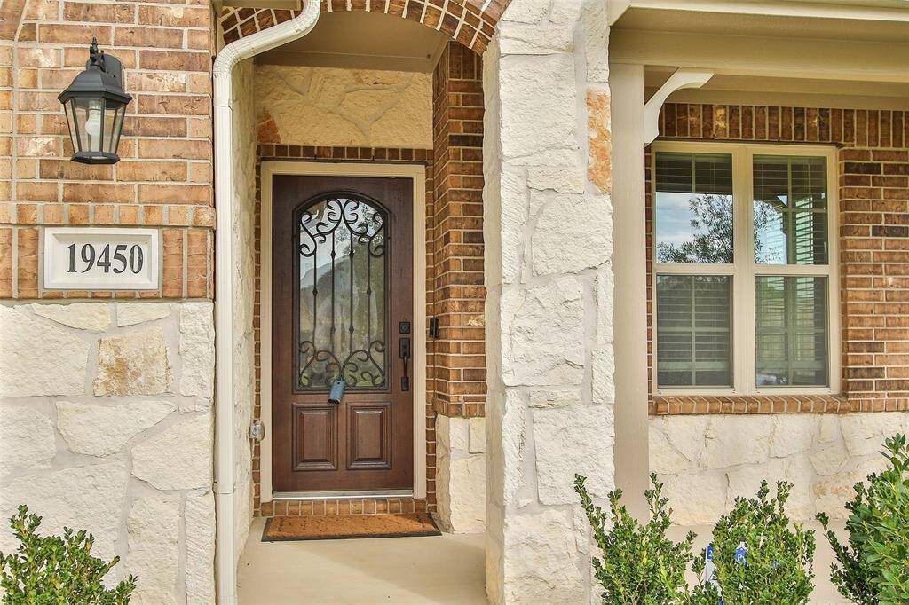 The stone and brick elevation lends to wonderful curb appeal