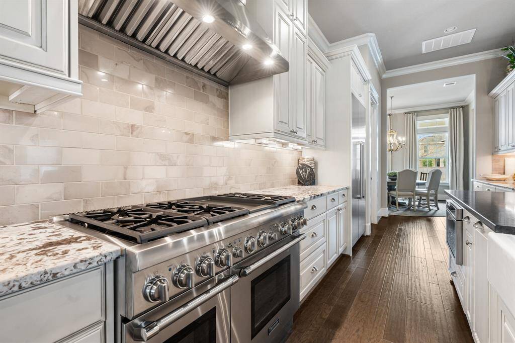 Thermador appliances include a 6 burner gas range with griddle, microwave, dishwasher and refrigerator.