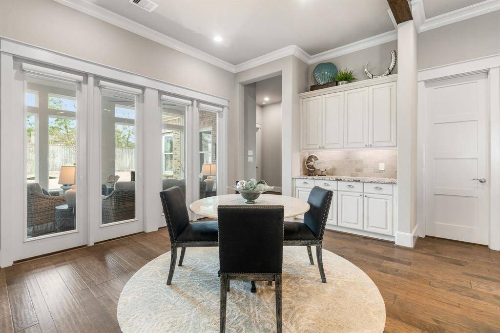 Exuding charm all its own, this inviting breakfast space is open to the sun room. Additional home upgrades include Hunter Douglas Blinds.