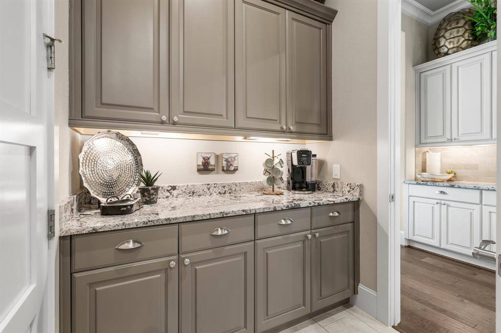 Additional storage and perfect for a coffee bar, this second butler pantry / mud area is off the garage entry.