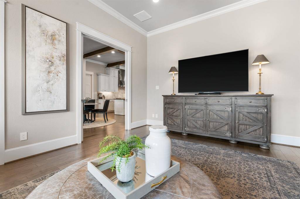 A first floor flex space with pocket doors makes for an additional sitting, media, game or play room.