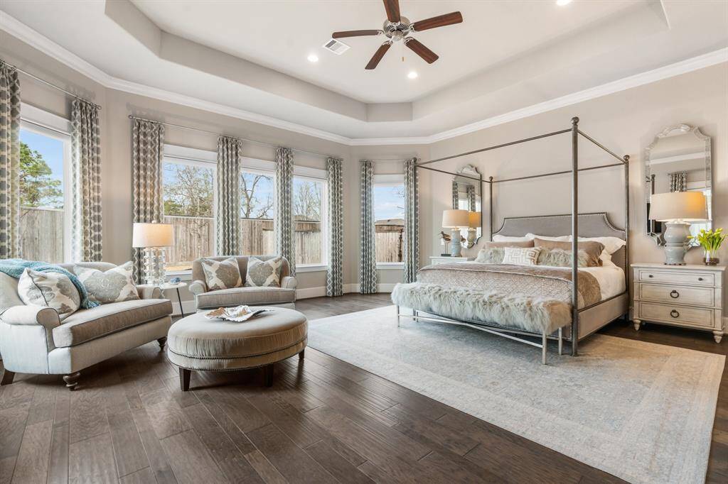 Simply gorgeous - with a wall of windows and abundant natural light, the primary bedroom presents a serene retreat to start and end your day by.