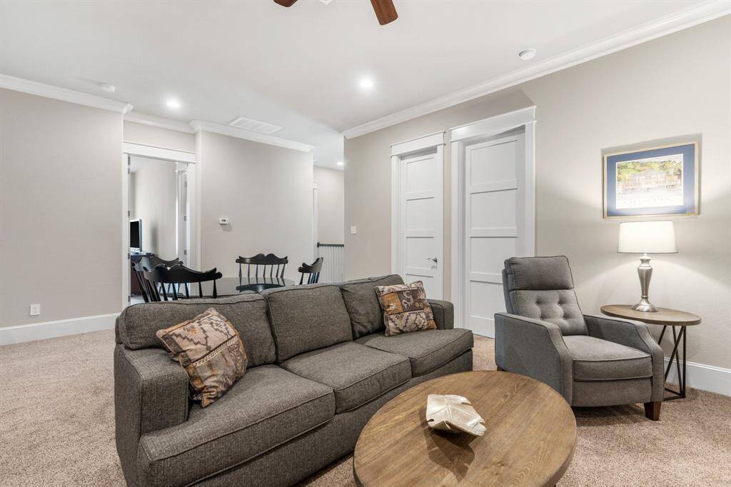 A warm and cozy second-floor game room offers the perfect gathering space for fun and relaxation, accompanied by three additional bedrooms and a finished storage room for added convenience.