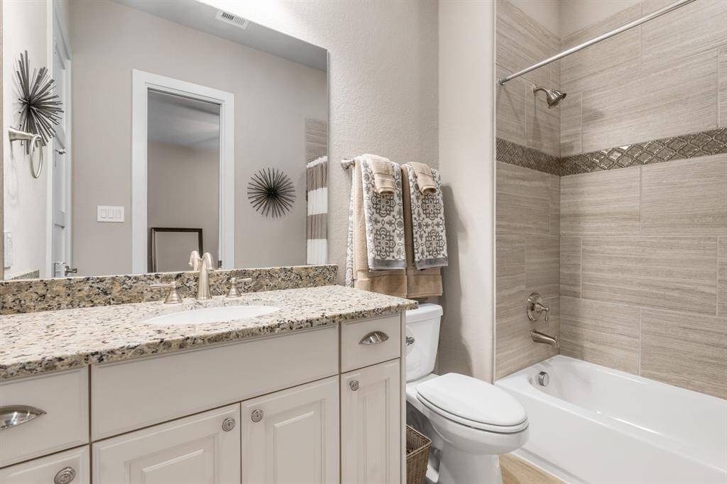 This bedroom highlights an ensuite bath with tub/shower combination.