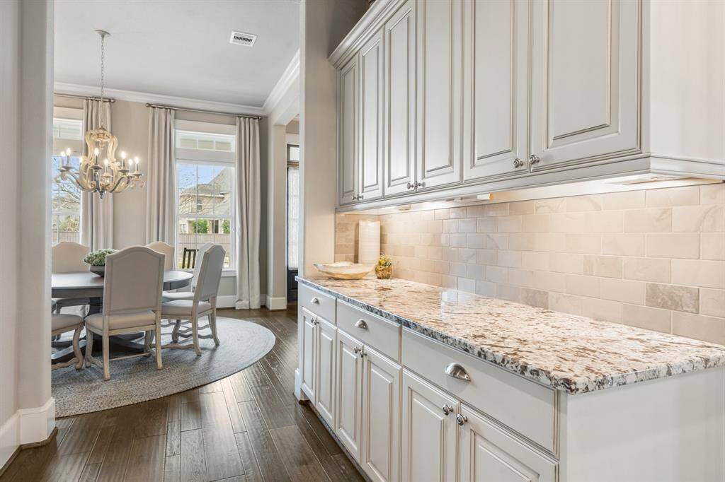 Between the kitchen and dining, a well thought butler's pantry has generous storage, undercabinet lighting and plenty of serving space.