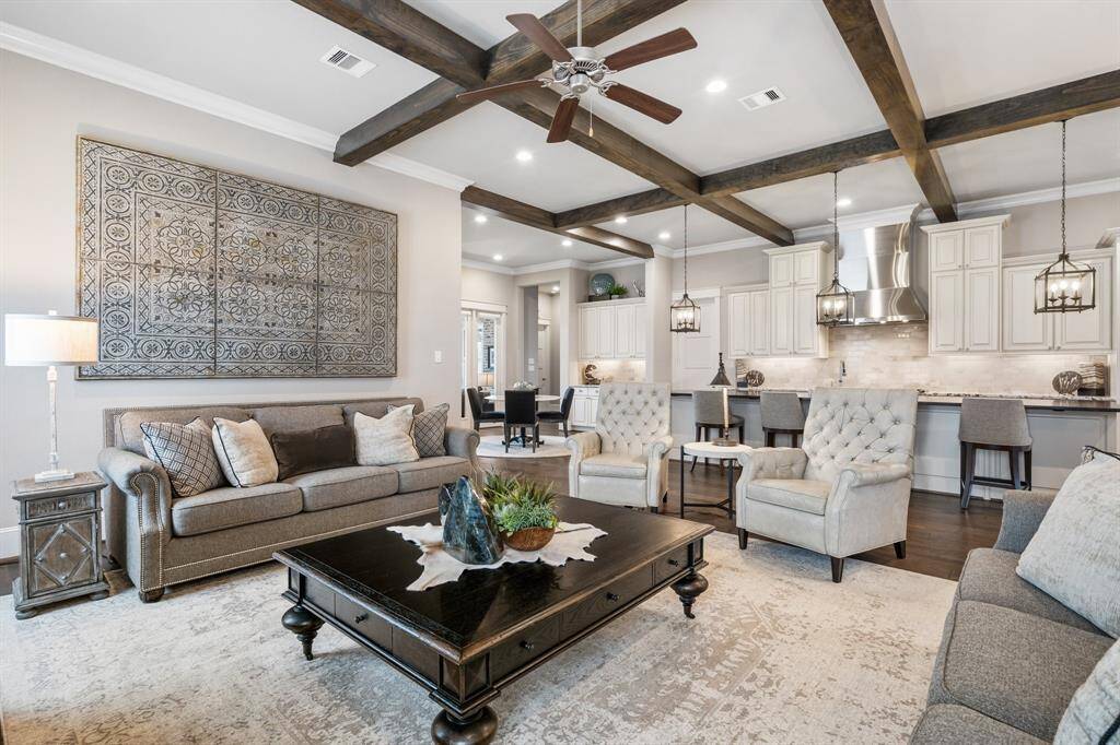 Plenty of wow-factor and comfortable living, the family room showcases beautiful wood accent beams.