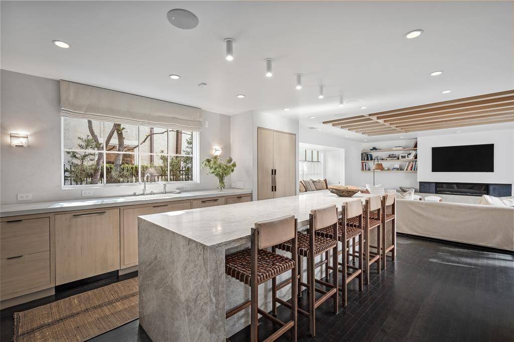 Kitchen with 11 ft marble island, double dishwashers, white oak cabinets and fronts built on site, plaster, stone pendant lighting.