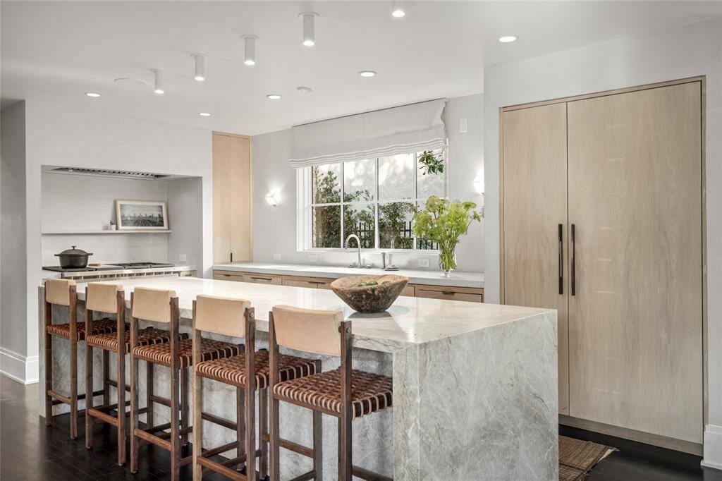 Another view of kitchen. A power strip is installed under the length of the island for charging devices