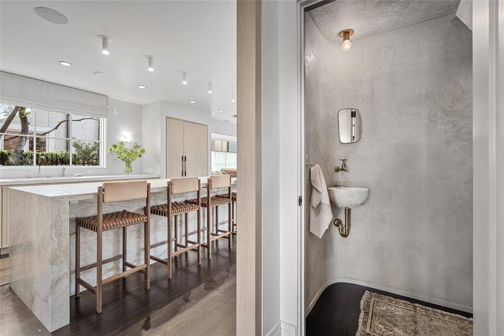 Plaster powder room with curved accent wall and sink from Chateau Domingue.