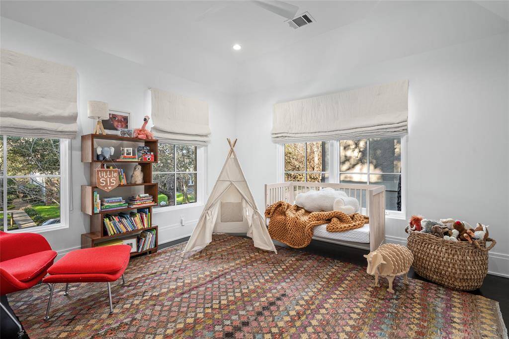 Front secondary bedroom flooded with natural light.