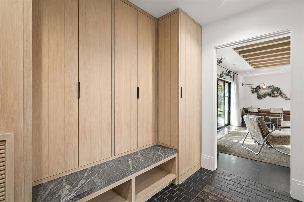 Stained white oak mudroom off the family room, across from the utility and leading to the garage and back staircase