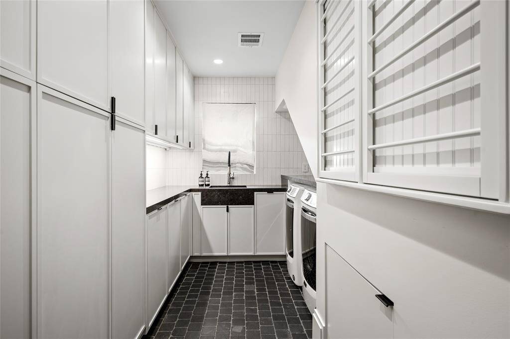 Utility room complete with sink and dog feeding station