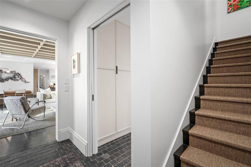 View showing the back staircase to the playroom / quarters looking back at utility room entrance and family room