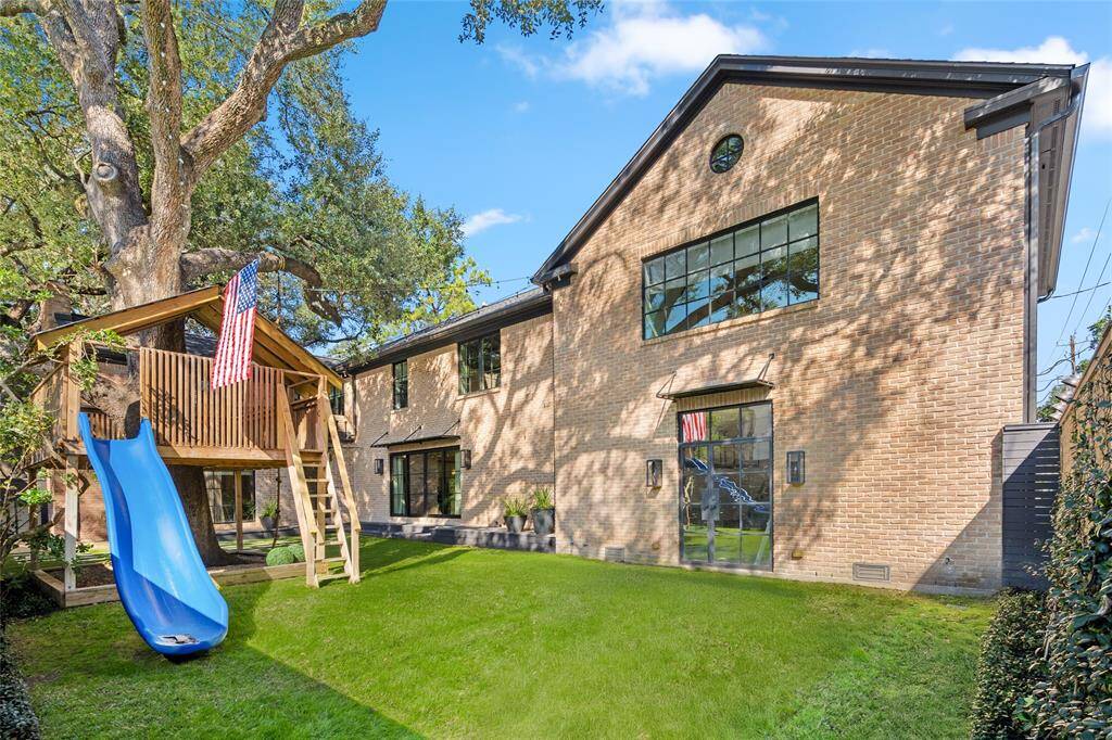 View showing the addition (matched brick), access to the garage, playroom above.