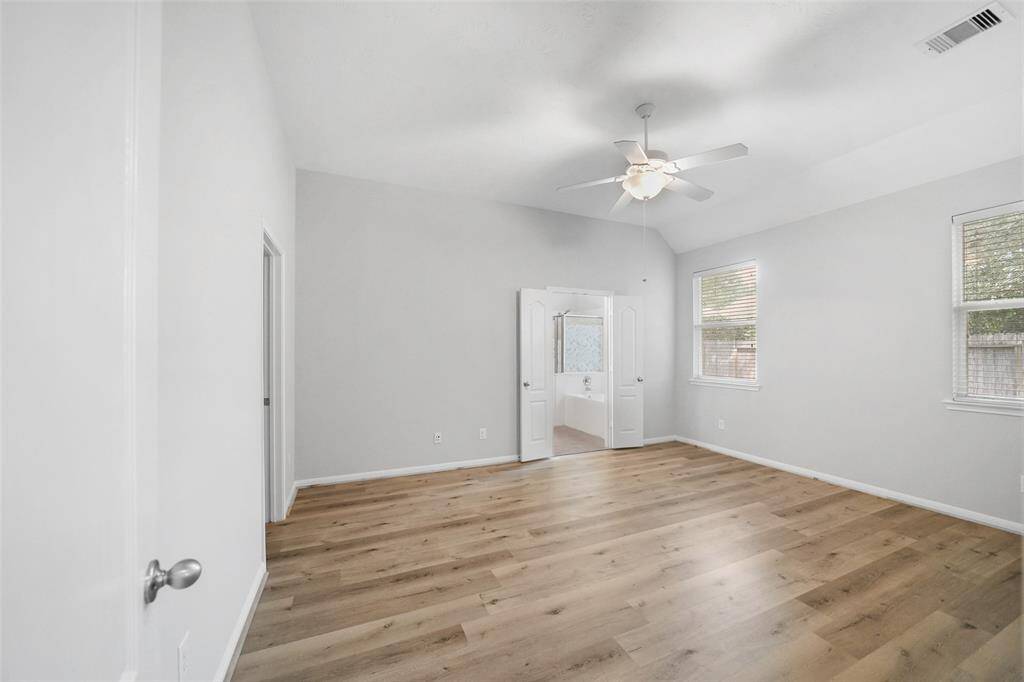 This spacious primary bedroom offers the perfect place to unwind, with plenty of room to relax and recharge.