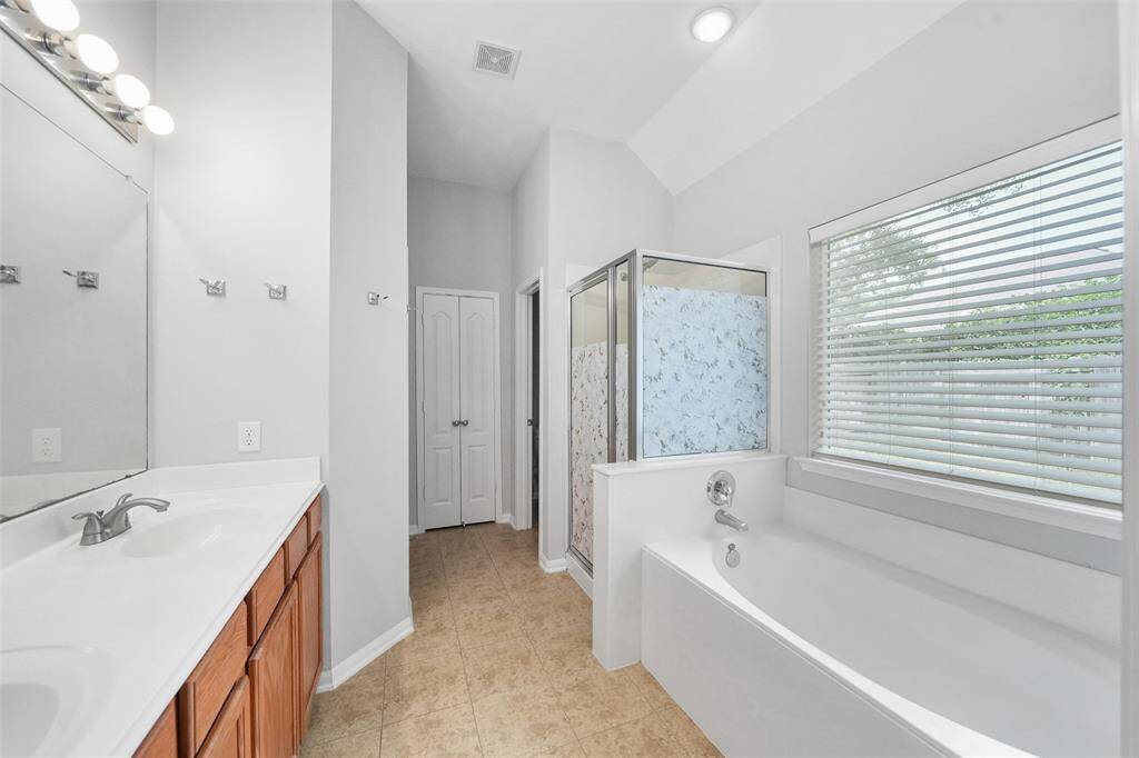 The spacious primary en suite bathroom, includes a luxurious soaking tub and a double vanity with ample space for both. Plus you'll enjoy the comfort of two walk-in closets for plenty of storage!