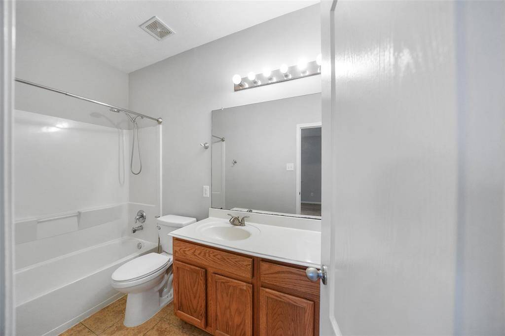 The second bath, shared by the secondary bedrooms, conveniently located between both secondary bedrooms with a full bathtub!