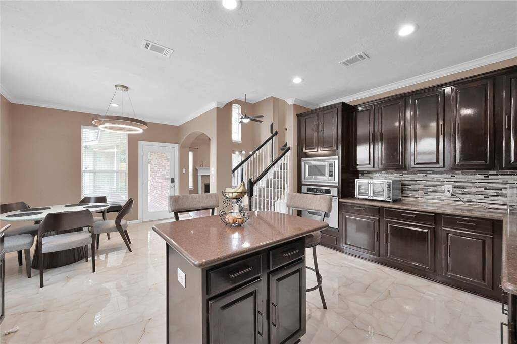 Enjoy coffee or collaborating around the island. Kitchen with newly painted walls and newly refinished cabinets is functional and has plenty of storage.