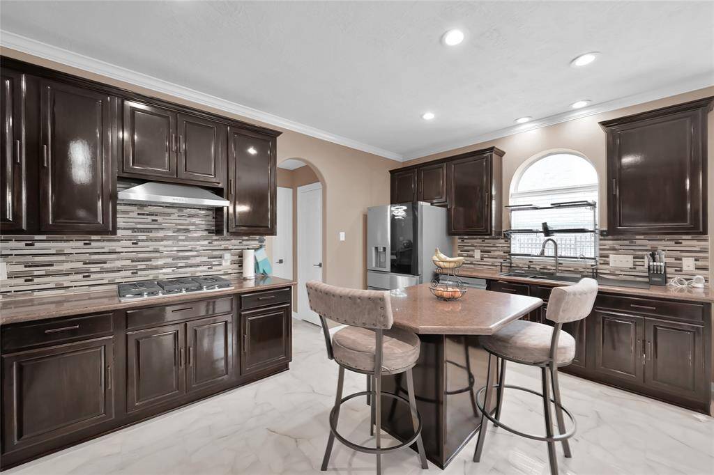 Never run out of space to store things. There are 31 cabinets and 10 drawers. Gas cooktop, new backsplash, new porcelain tile flooring.