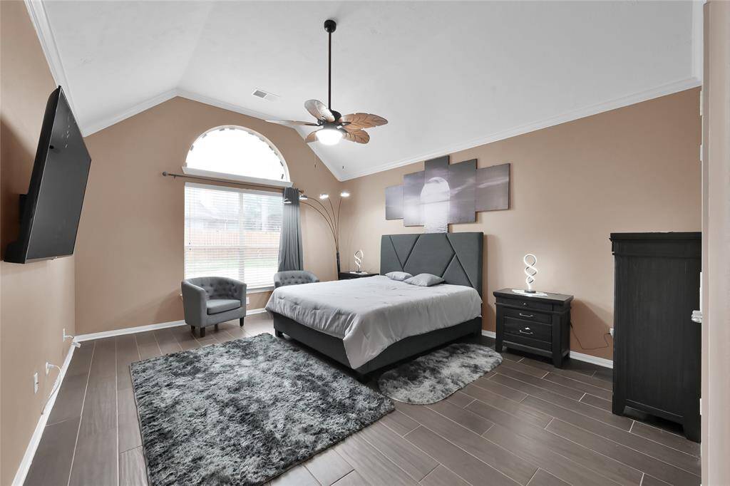 Bring all your furnishings to this very large primary bedroom with new tile floors and leaf ceiling fan. The lunette window is a bonus!