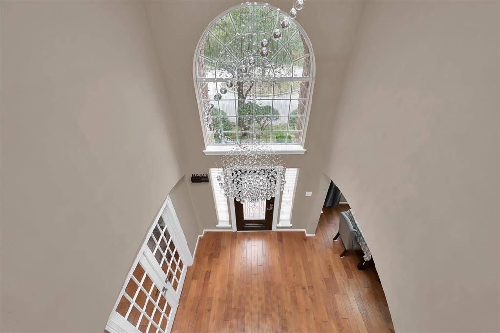 This entry is wide and open. The front door adorns two skylights. The exquisite chandelier in front entry has been meticulously assembled for this foyer.