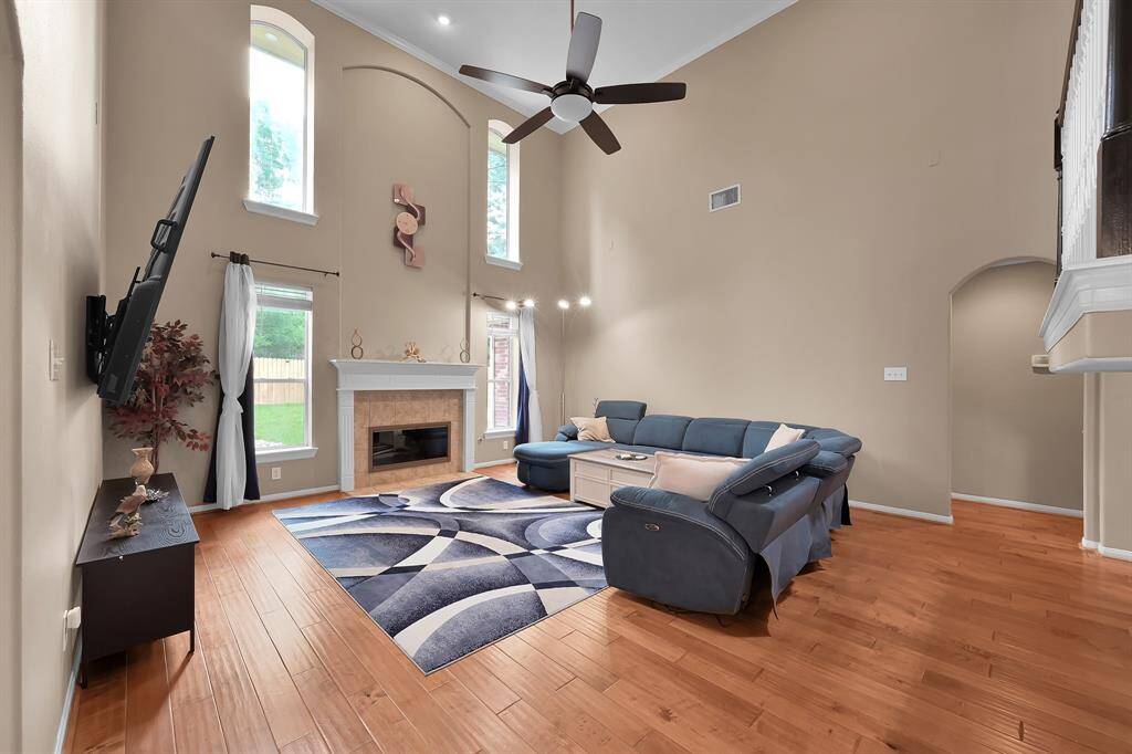 Plenty space in this living room for living! The fireplaces take all the spotlight and offers accent space for large art work. This space is accented classical crown molding, baseboards, new ceiling fan.