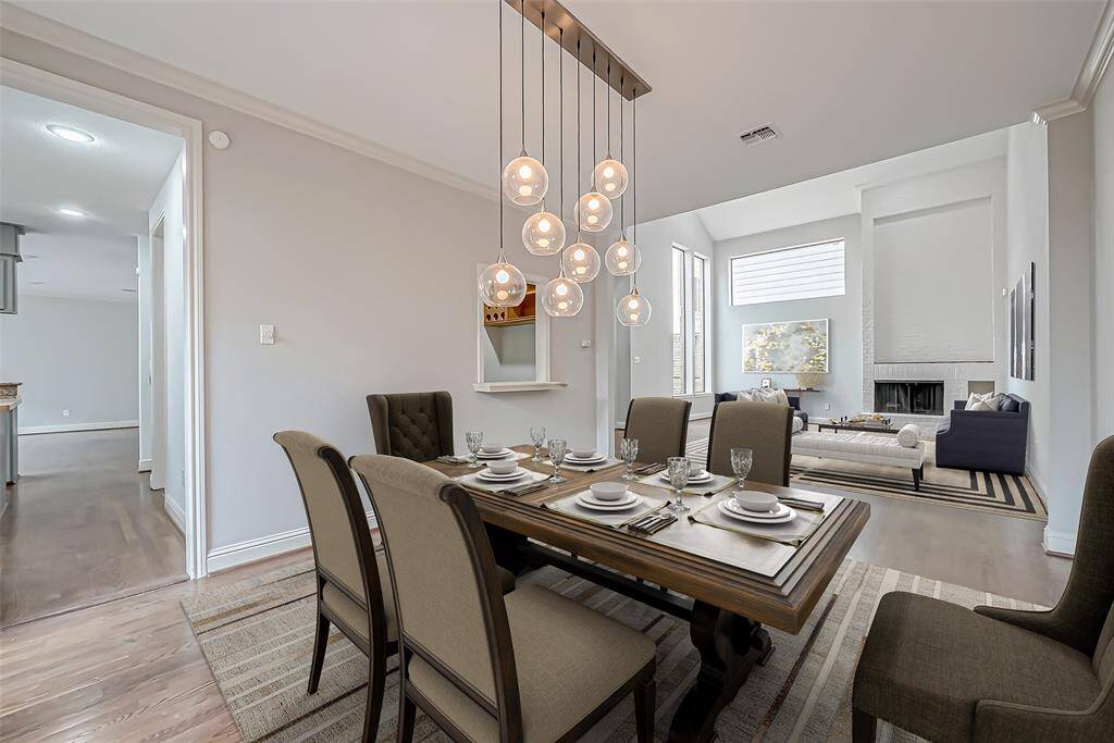 Formal dining room with beautiful light fixture. Fits a large dinning table.